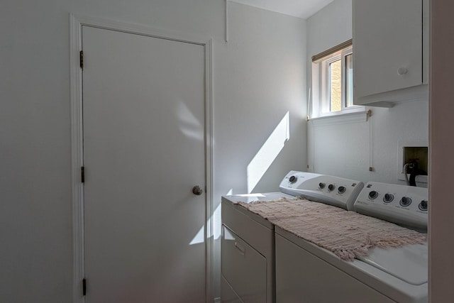 clothes washing area with cabinet space and separate washer and dryer