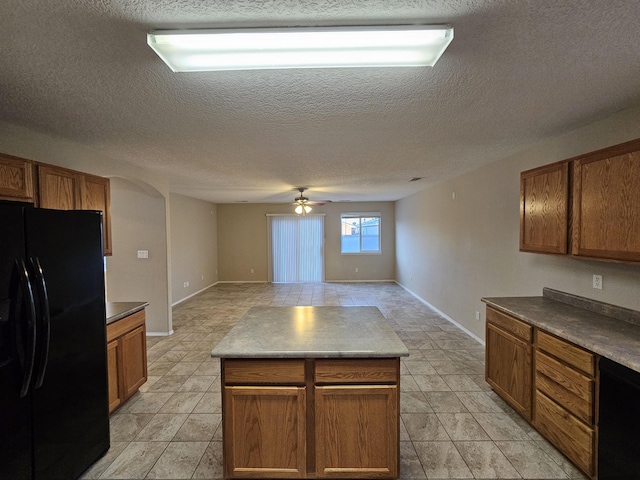 6619 Country Hills Ct NW, Albuquerque, NM 87114 - kitchen with open floor plan, brown cabinets, freestanding refrigerator, and ceiling fan