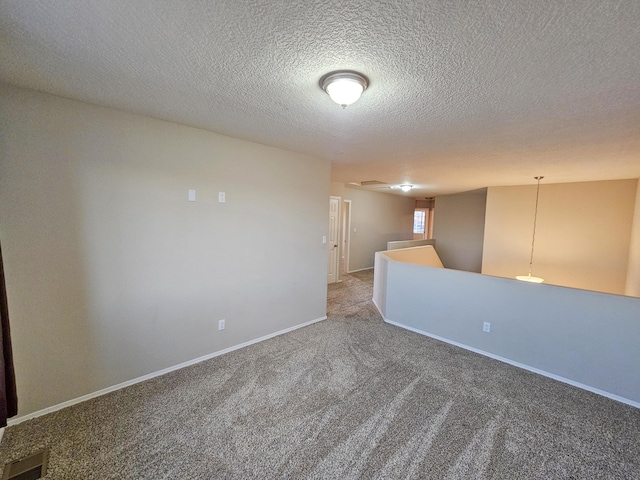 6619 Country Hills Ct NW, Albuquerque, NM 87114 - carpeted spare room featuring visible vents, baseboards, and a textured ceiling