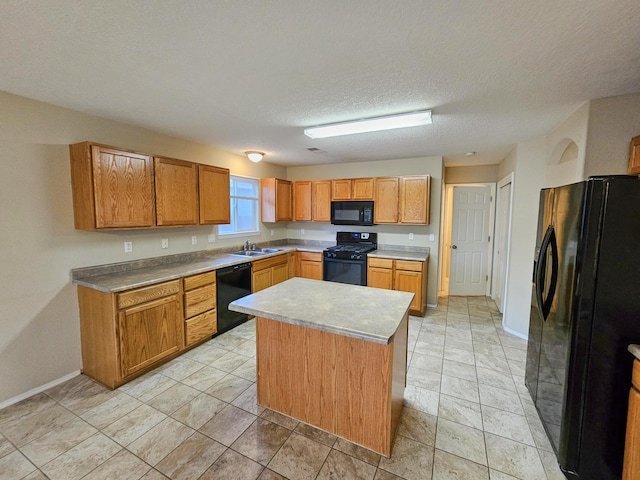 6619 Country Hills Ct NW, Albuquerque, NM 87114 - kitchen featuring baseboards, a kitchen island, a sink, black appliances, and a textured ceiling