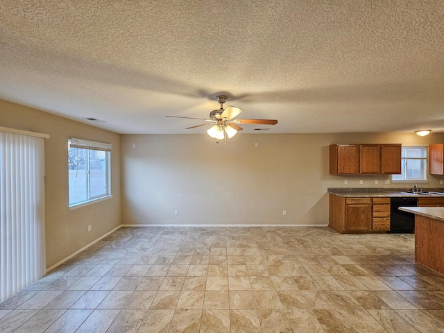 6619 Country Hills Ct NW, Albuquerque, NM 87114 - kitchen featuring brown cabinetry, baseboards, visible vents, ceiling fan, and dishwasher