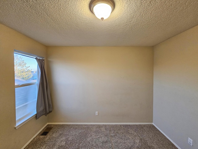 6619 Country Hills Ct NW, Albuquerque, NM 87114 - carpeted spare room featuring visible vents, baseboards, and a textured ceiling