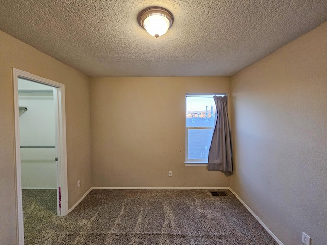 6619 Country Hills Ct NW, Albuquerque, NM 87114 - carpeted empty room with visible vents, a textured ceiling, and baseboards