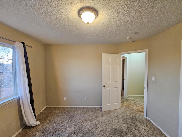 6619 Country Hills Ct NW, Albuquerque, NM 87114 - empty room featuring a textured ceiling, baseboards, and carpet