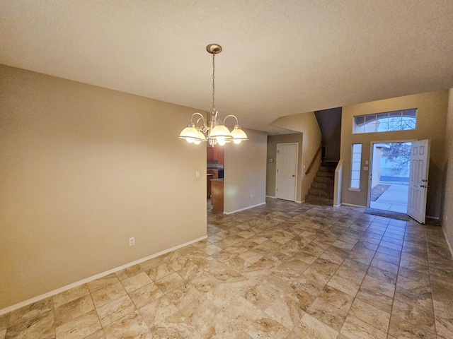 6619 Country Hills Ct NW, Albuquerque, NM 87114 - unfurnished room featuring stairs, an inviting chandelier, baseboards, and a textured ceiling