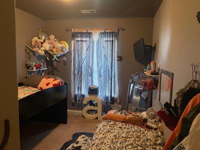 carpeted bedroom featuring visible vents