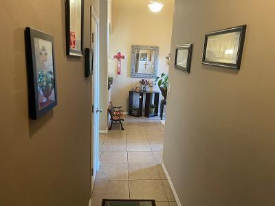 hallway with light tile patterned floors and baseboards