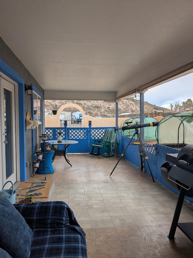 view of patio / terrace featuring fence