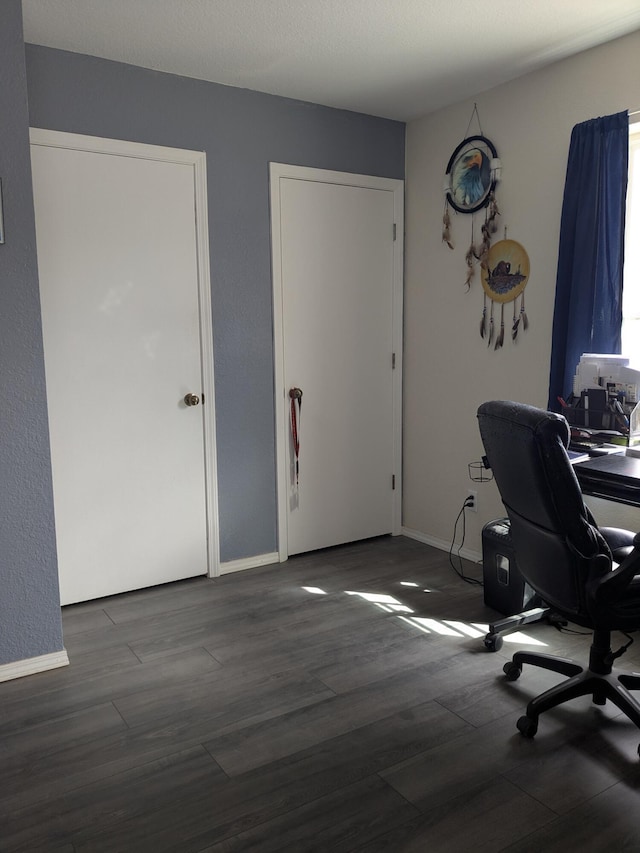 home office featuring baseboards and wood finished floors