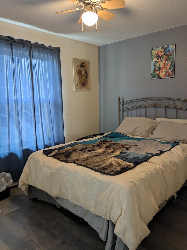 bedroom featuring a ceiling fan and dark wood finished floors