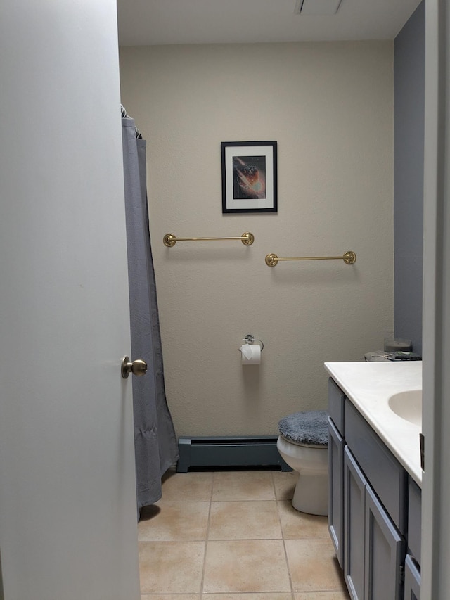 bathroom featuring toilet, baseboard heating, tile patterned flooring, and vanity