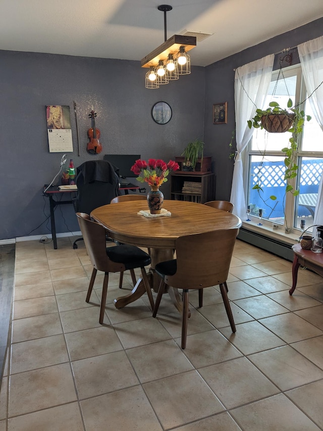 dining area featuring light tile patterned floors and baseboards