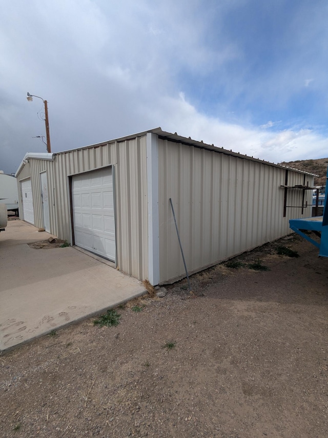 view of outbuilding featuring a garage and an outdoor structure