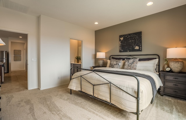 carpeted bedroom featuring baseboards, freestanding refrigerator, visible vents, and recessed lighting