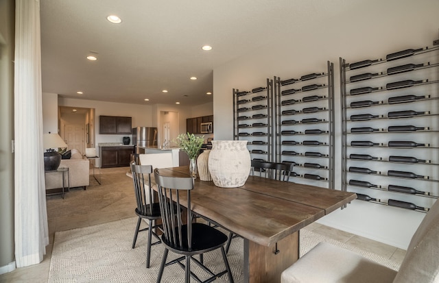 dining space with light tile patterned floors and recessed lighting