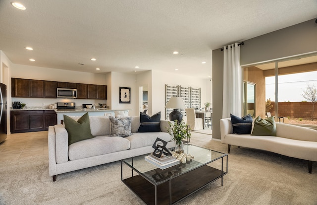 living room featuring light tile patterned floors, a textured ceiling, and recessed lighting