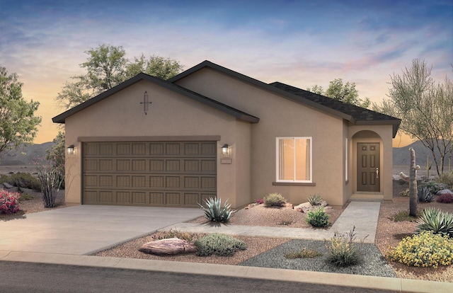 ranch-style home featuring driveway, an attached garage, and stucco siding