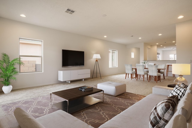 living room with carpet floors, visible vents, and recessed lighting