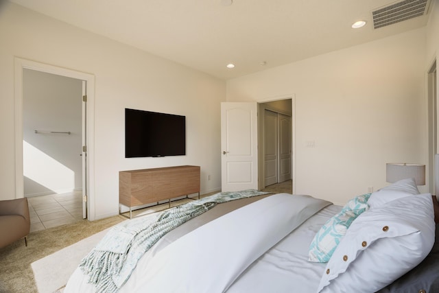 carpeted bedroom with baseboards, tile patterned flooring, visible vents, and recessed lighting