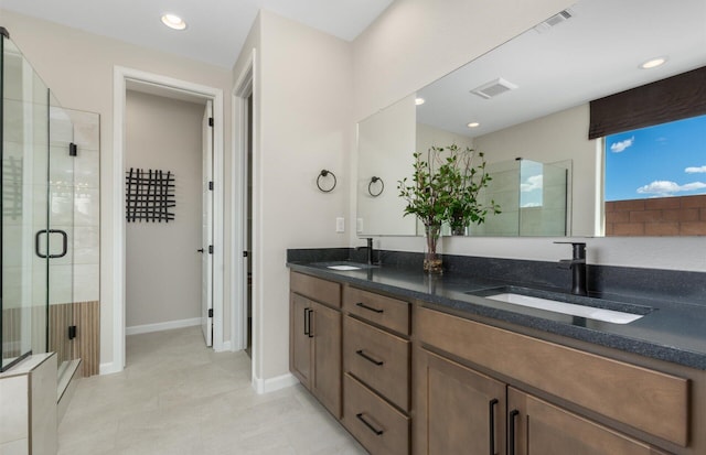 bathroom featuring a sink, visible vents, and a stall shower