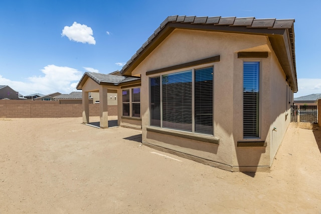 2158 Janet Way, Rio Rancho, NM 87144 - rear view of house with stucco siding, a fenced backyard, and a patio area
