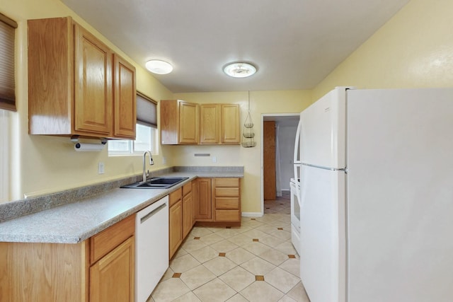 kitchen with light tile patterned flooring, white appliances, light countertops, and a sink