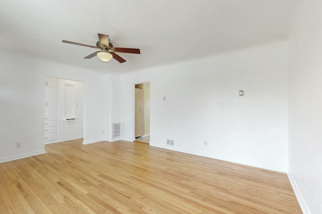 unfurnished room featuring light wood-type flooring, baseboards, visible vents, and ceiling fan