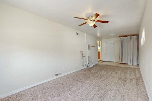 empty room with visible vents, light colored carpet, and baseboards