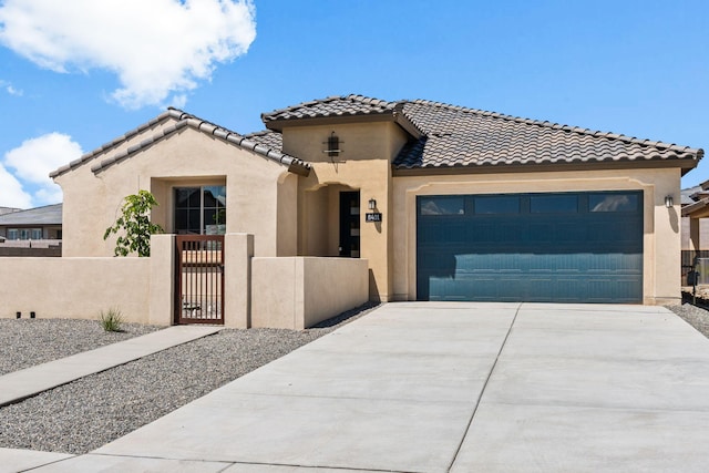 8401 Twain Way NW, Albuquerque, NM 87114 - mediterranean / spanish home featuring a fenced front yard, stucco siding, a garage, driveway, and a gate