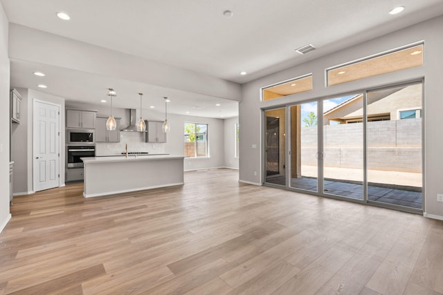8401 Twain Way NW, Albuquerque, NM 87114 - unfurnished living room featuring light wood-style floors, recessed lighting, and baseboards