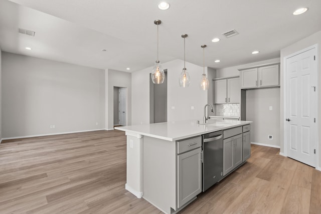 8401 Twain Way NW, Albuquerque, NM 87114 - kitchen featuring stainless steel dishwasher, a sink, gray cabinetry, light wood-type flooring, and light countertops
