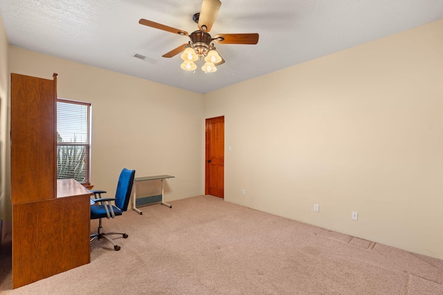 office with a ceiling fan, visible vents, and carpet floors