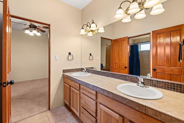 full bathroom featuring a sink, ceiling fan with notable chandelier, double vanity, and tile patterned flooring