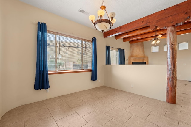 tiled spare room with visible vents, beamed ceiling, and ceiling fan with notable chandelier