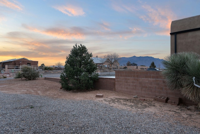 view of yard featuring a mountain view and fence