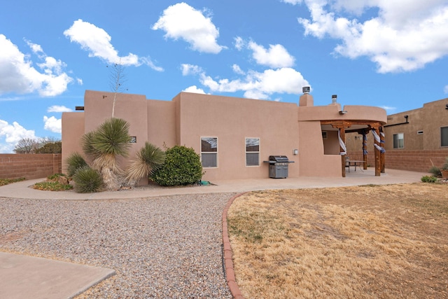 exterior space featuring stucco siding, fence, and a patio area