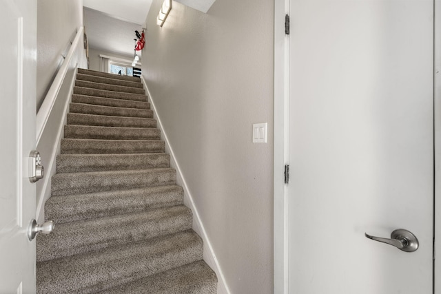 staircase featuring baseboards