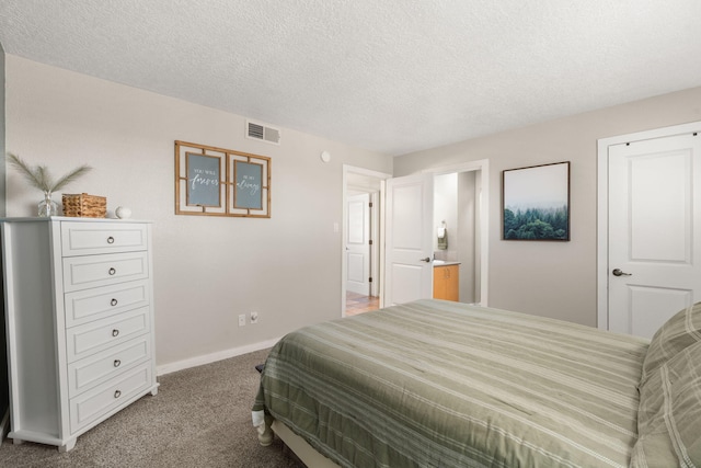 carpeted bedroom featuring baseboards, visible vents, and a textured ceiling