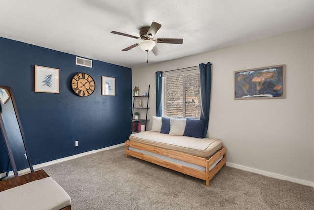 sitting room with carpet flooring, baseboards, visible vents, and ceiling fan