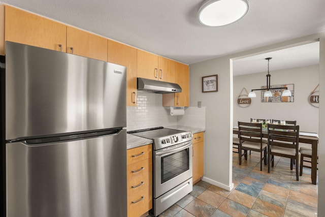 kitchen featuring decorative backsplash, hanging light fixtures, light countertops, under cabinet range hood, and appliances with stainless steel finishes