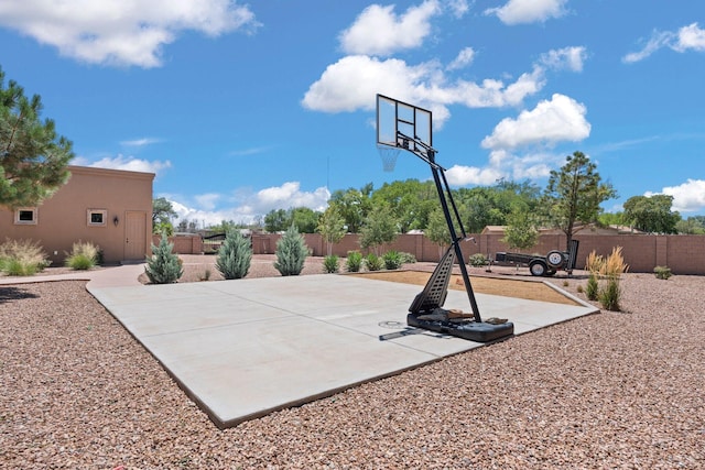 view of sport court with basketball court and fence