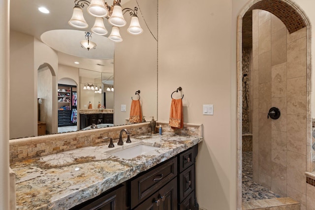 full bath with vanity, radiator heating unit, and tiled shower