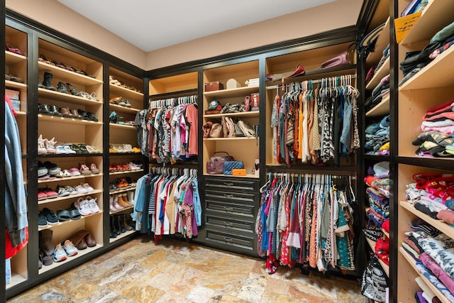 spacious closet with stone finish flooring