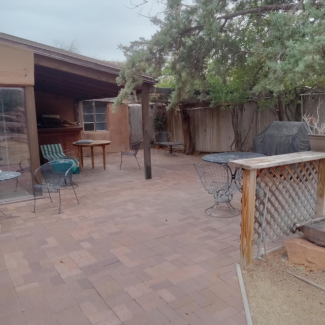 view of patio / terrace with area for grilling and fence