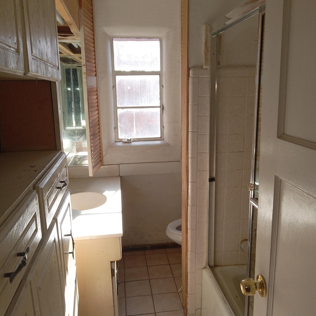 bathroom with tile patterned flooring, toilet, vanity, and bathtub / shower combination