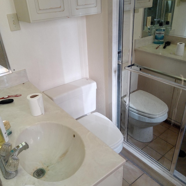 bathroom featuring tile patterned floors, toilet, and vanity