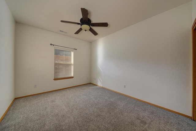 empty room with visible vents, light carpet, baseboards, and a ceiling fan