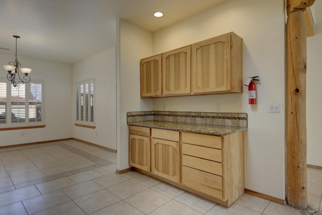 kitchen with visible vents, a notable chandelier, light brown cabinetry, light tile patterned floors, and baseboards