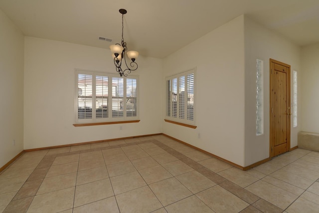 spare room with light tile patterned floors, visible vents, baseboards, and a chandelier