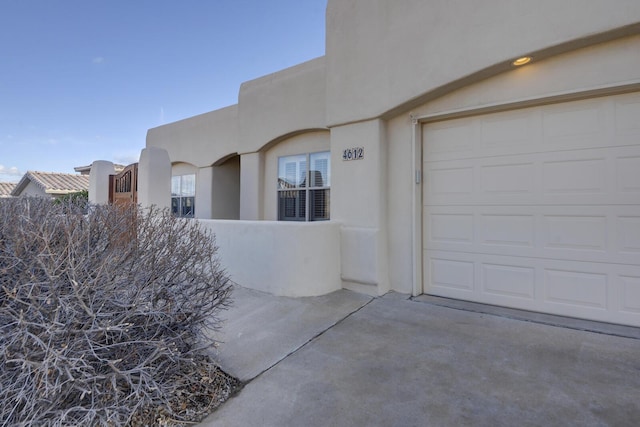 exterior space with stucco siding and a garage